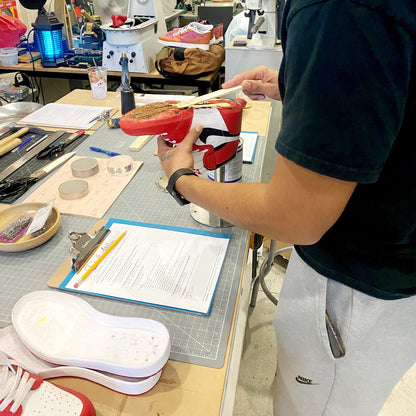 The application of cork to the void on a traditional lasting style to create a smooth bottom prior to attaching the sole to your custom made upper.